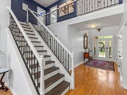 a look inside the home hallway right inside the door there is a widespread hallway with lots of room and a stairway to the second floor.