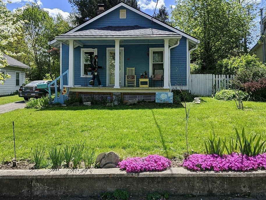 bright blue lincoln ave home bright flowers in the landscape & a beautiful shade of blue as the homes color